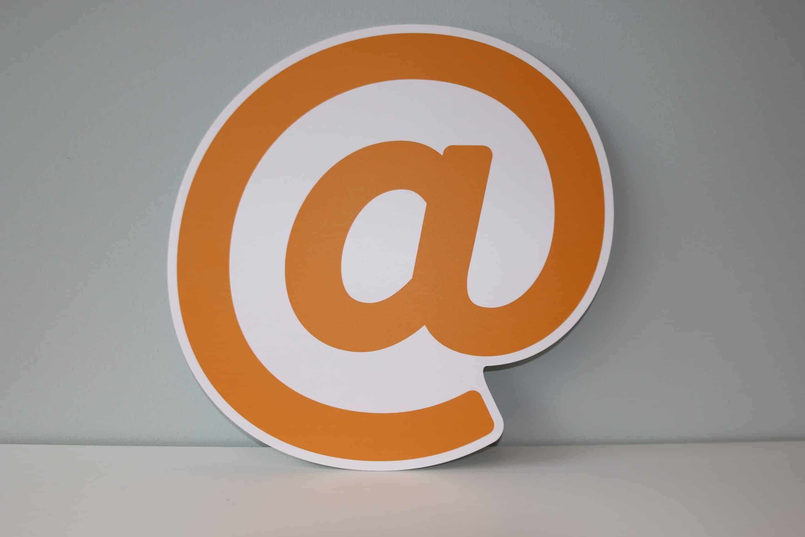 orange email symbol against a grey wall