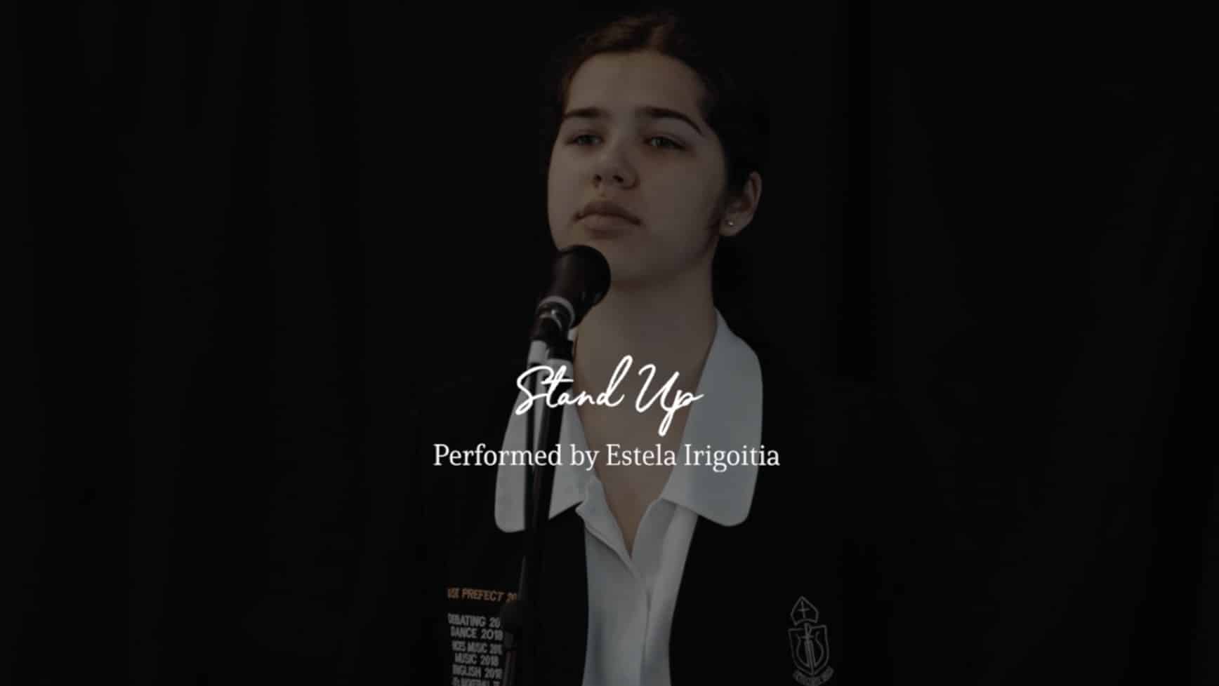 School girl singing in front of microphone and black background